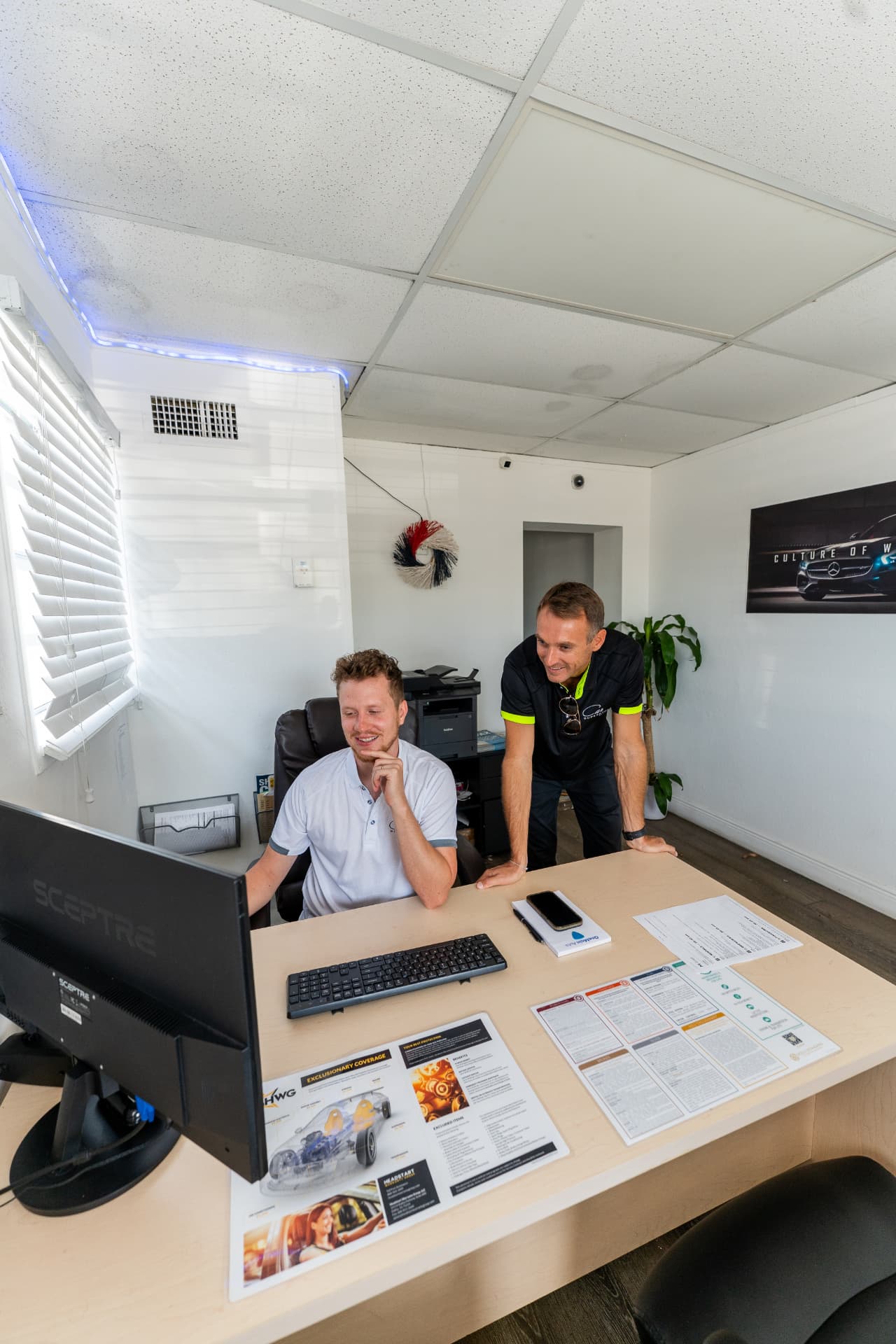 Car Superstore team assisting customers in the dealership office